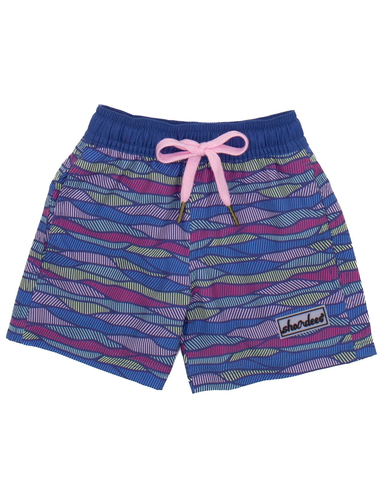 A pair of Properly Tied Youth - Boys Shordee Malibu Wave Swim Trunks laid out on a white surface. The swim trunks feature a vibrant wave pattern in shades of blue and teal, with an elastic waistband for a comfortable fit. The image also includes a matching straw hat in the background, available in both youth and adult sizes.