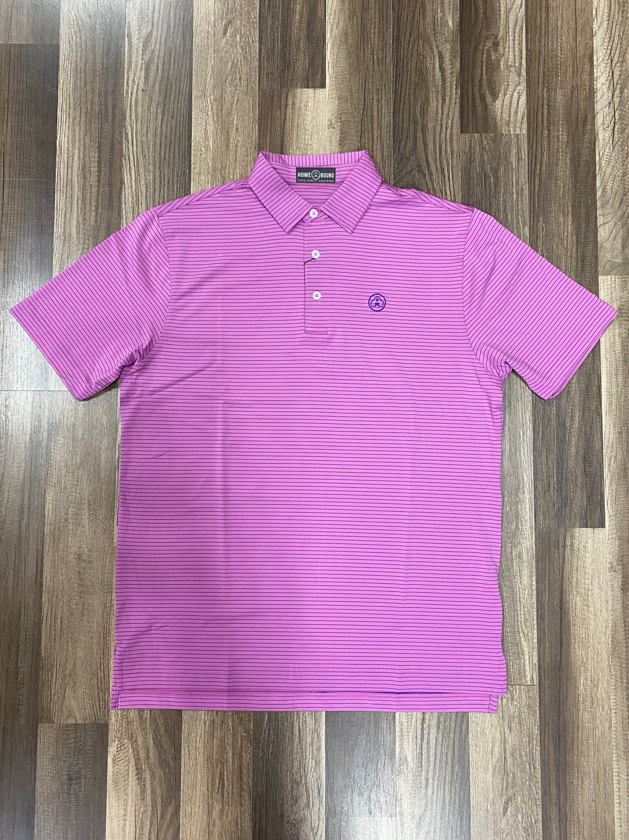 Home Bound Apparel Original Azalea Pink Performance Polo with Thin Cobalt Blue Stripes on a model showcasing vibrant style and comfortable fit for active lifestyles.