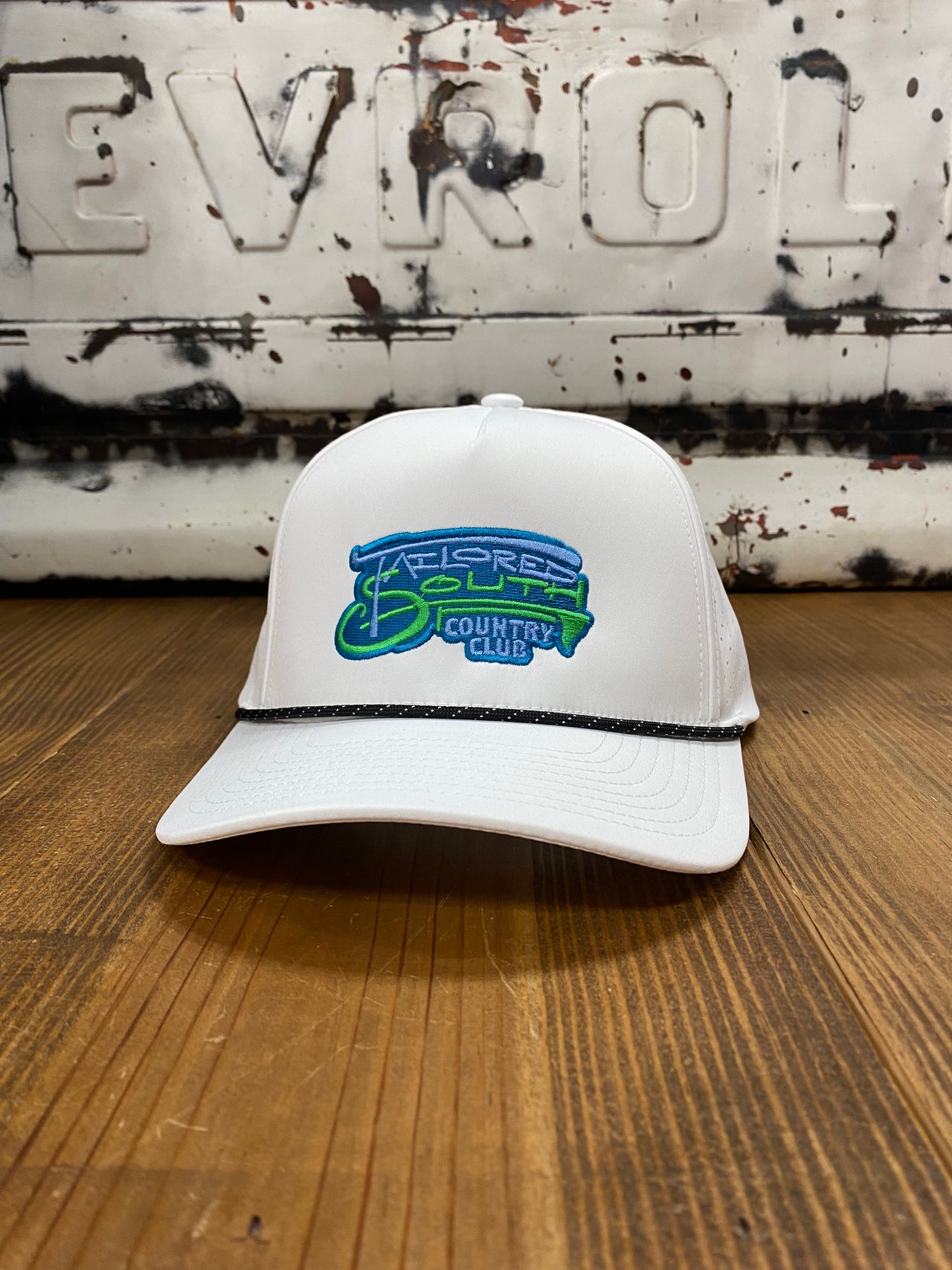 Tailored South White Performance Snapback: A dynamic 5-panel cap with neon green and neon blue embroidered writing, offering a vibrant and stylish accessory for active lifestyles.