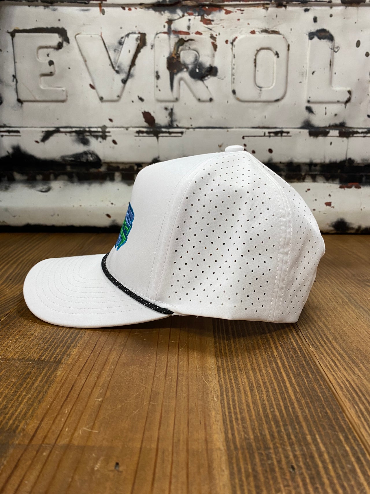 Tailored South White Performance Snapback: A dynamic 5-panel cap with neon green and neon blue embroidered writing, offering a vibrant and stylish accessory for active lifestyles.