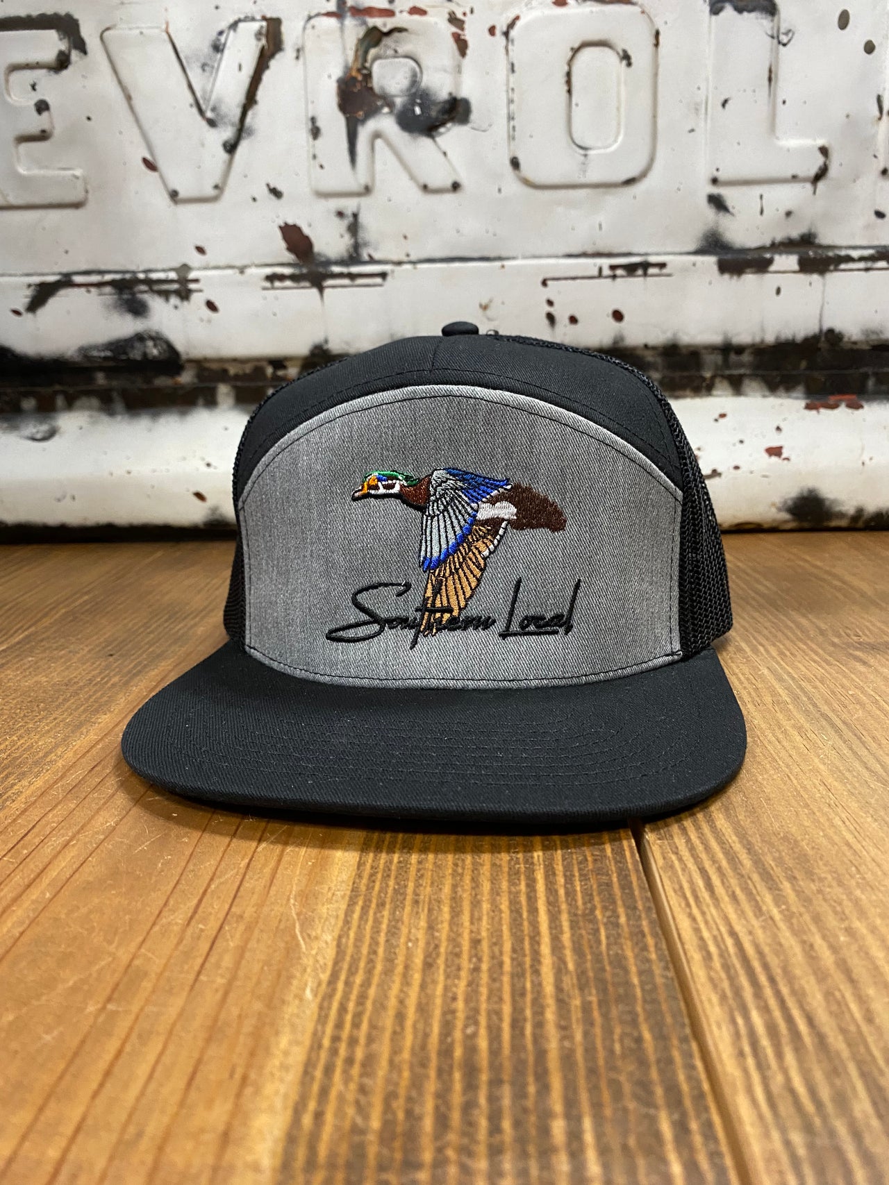 Heather Grey/Black Southern Local Wood Duck 7 Panel Cap - A blend of classic style and Southern charm. Distinctive wood duck embroidery adds character to this meticulously crafted cap. Comfortable seven-panel construction, premium materials, and versatile design for city or outdoor adventures.