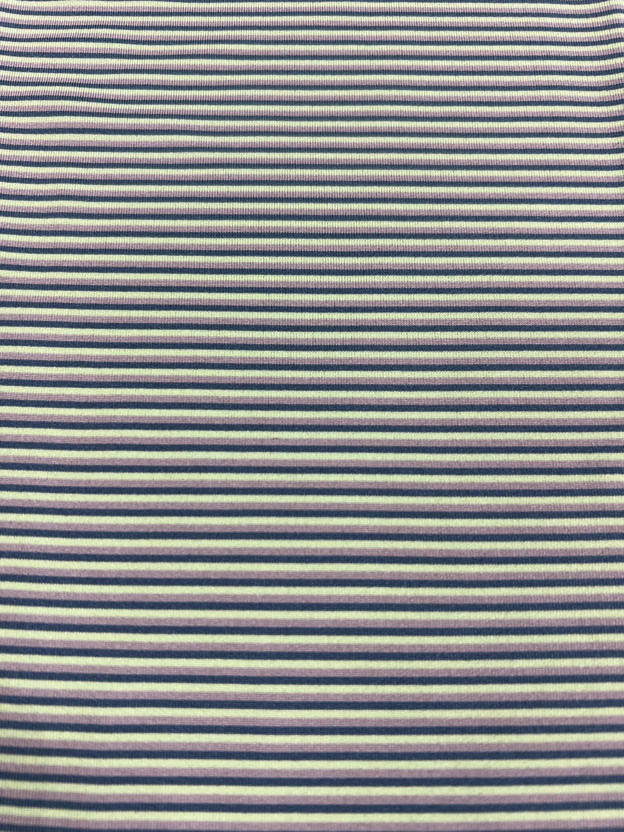 A close-up image of a lime, silver, and teal striped polo shirt from Home Bound Brand, showcasing its vibrant colors and modern design.