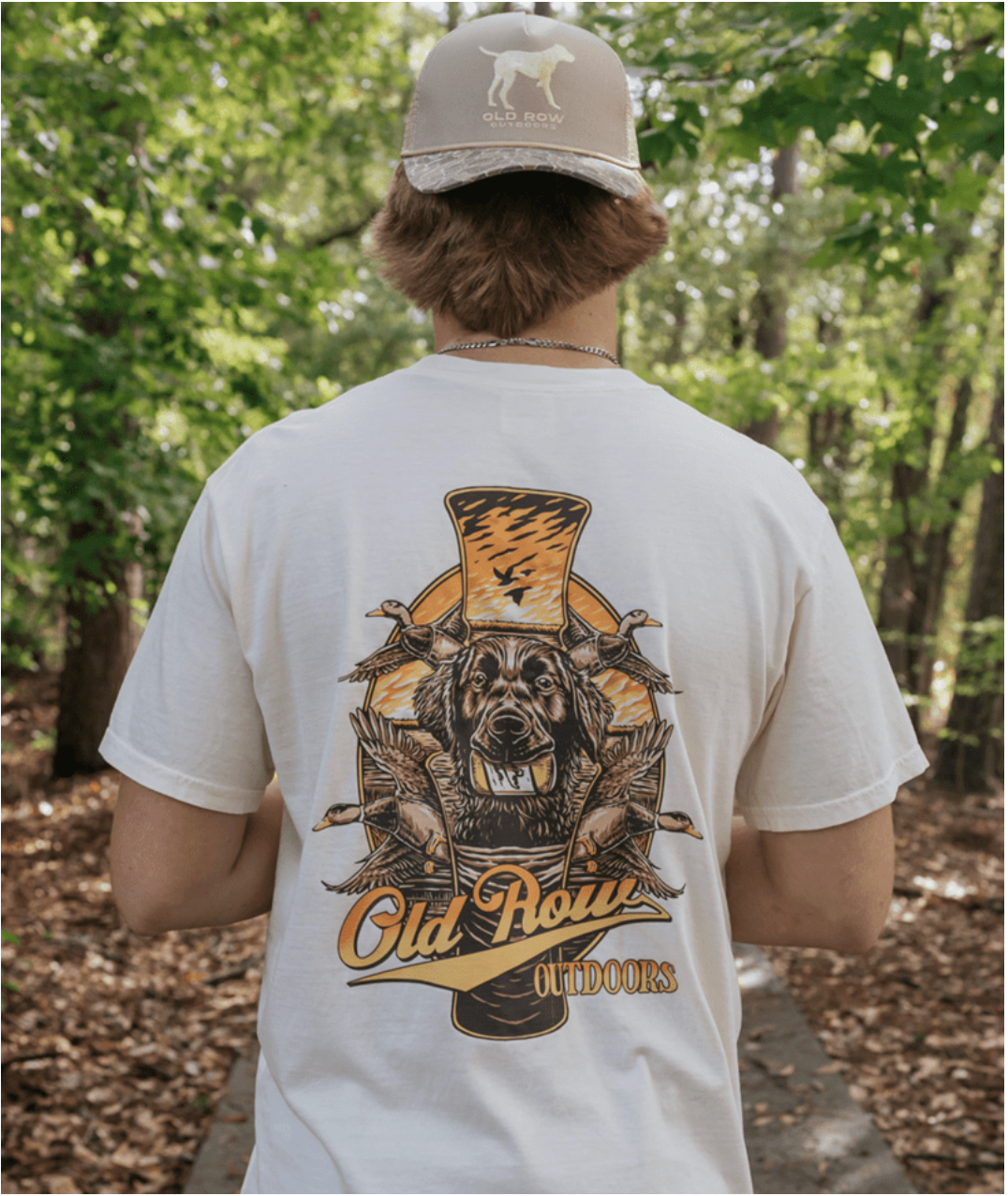 Old Row On The Hunt Short Sleeve T-Shirt in Ivory featuring a duck retriever holding a duck with flying mallards and Old Row Outdoors graphic on the back.